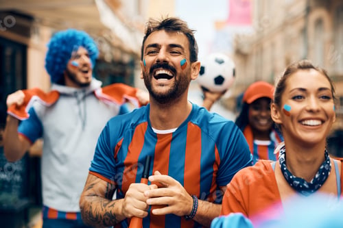 Preview: Excited soccer fan going on a match with group of his friends during the world championship.