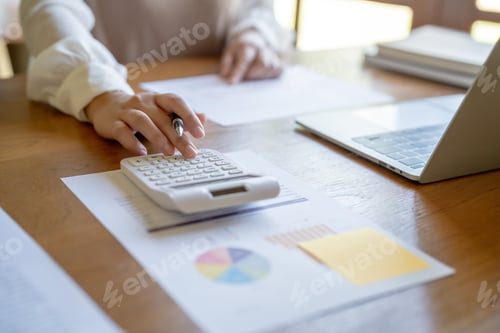 Preview: Businesswoman Accountant analyzing investment charts Invoice and pressing calculator buttons