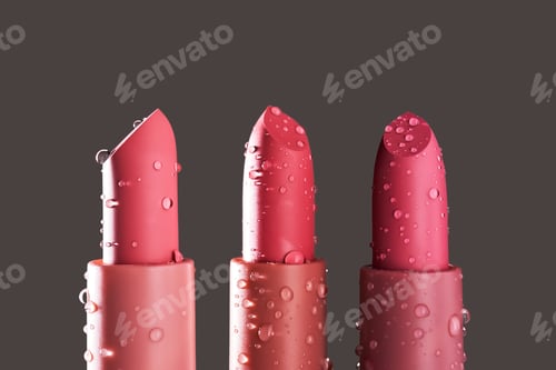 Preview: Red lipsticks with water drops on a dark background.