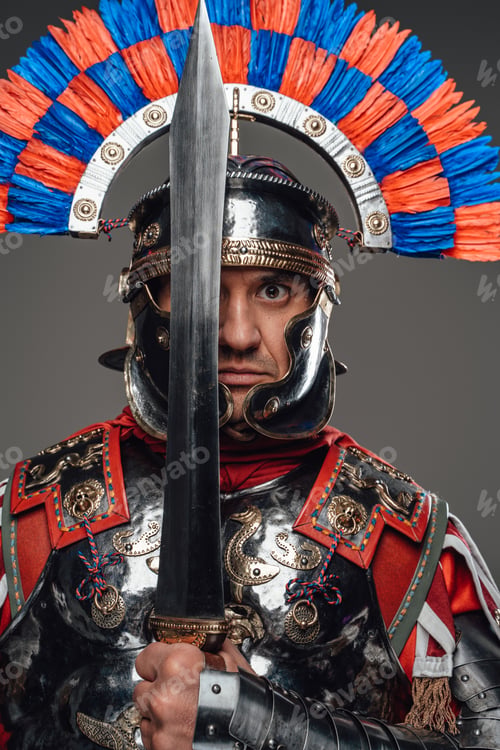 Preview: Proud roman soldier with gladius posing against gray background