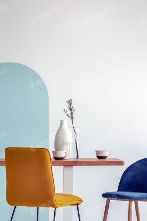 Preview: White vase on wooden table with fancy dining room interior with white and blue wall
