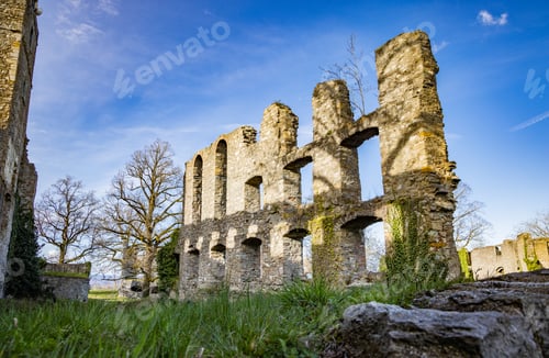 Preview: Ruins of Hohentwil with vegetation on Hegau volcano against sunny cloudy sky background
