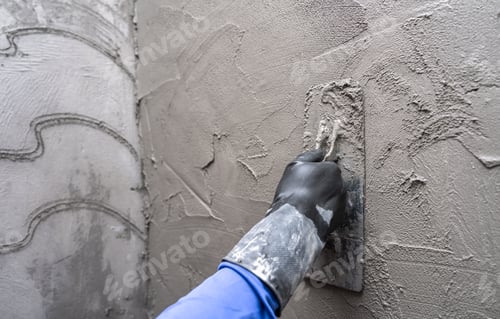 Preview: Hand plasterer plastering cement wall background, hand worker brush rough concrete floor for smooth