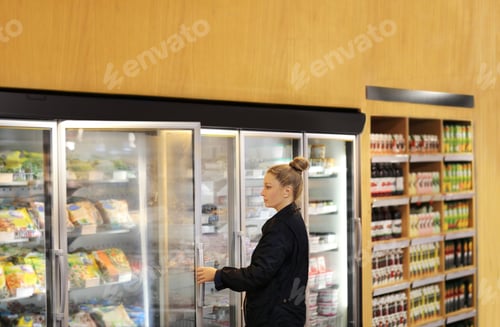 Preview: Woman Choosing Frozen Food From A Supermarket Freezer