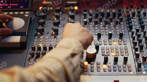 Preview: Sound designer working with sliders and switchers on control desk