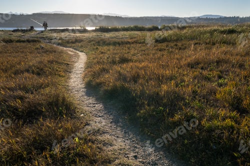Preview: Two fly fisherman on a well worn trail to a salt water beach in northwest Washington State, USA