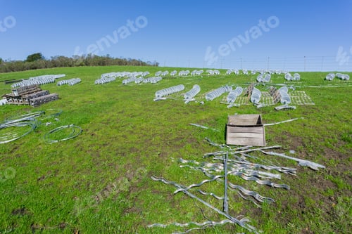 Preview: Ceramic insulators spread on a green meadow waiting to replace old ones, California
