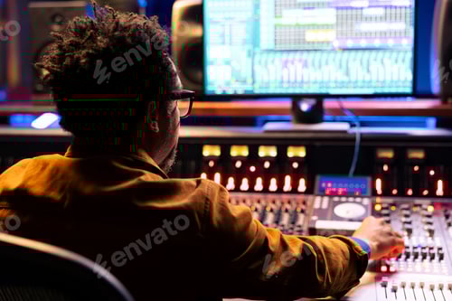 Preview: Sound engineer uses mixing console and handling panel board buttons