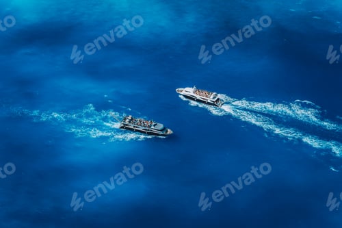 Preview: Two fully occupied tourist boats in open sea leaving and arriving in Navagio Beach on Zakynthos