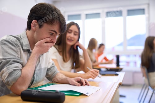 Preview: Shocked student looking at failed exam at school desk