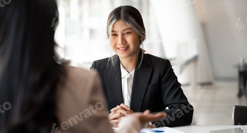 Preview: Bashful woman taking interview sitting at office