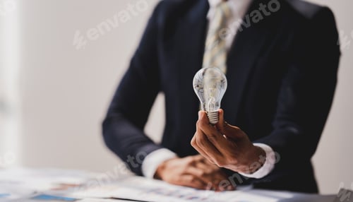 Preview: Hand holding a light bulb. Idea. Innovation concept with inspiration and energy saving concept.