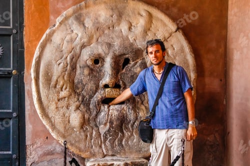Preview: A young tourist in the famous Bocca de la Verita in Rome. Italy
