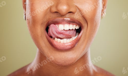 Preview: Tongue, teeth and african woman in closeup with lick, smile or happy for dental wellness in studio.