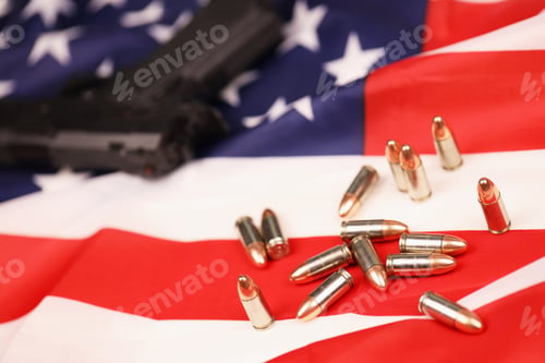 Preview: Many yellow 9mm bullets and gun on United States flag. Concept of gun trafficking on USA territory
