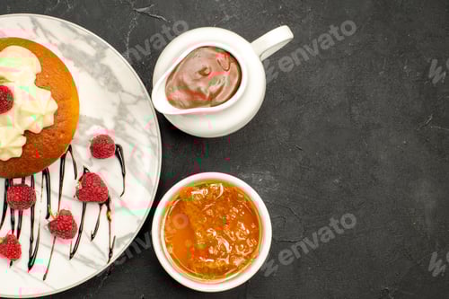 Preview: top view raspberry dessert made from cake and raspberriers decorated with cream and bitter