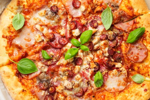 Preview: Delicious meat pizza with ham, salami and sausages.