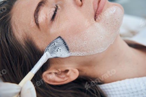 Preview: Close up of cosmetologist putting mask on face