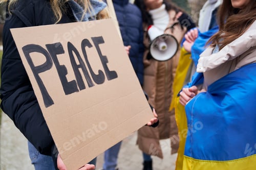 Preview: Unrecognizable people standing with manifest banners on cardboard