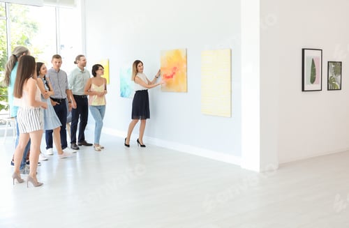 Preview: Group of people with guide at exhibition in art gallery