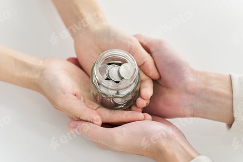 Preview: Donation Jar Held Securely in Two Pairs of Hands