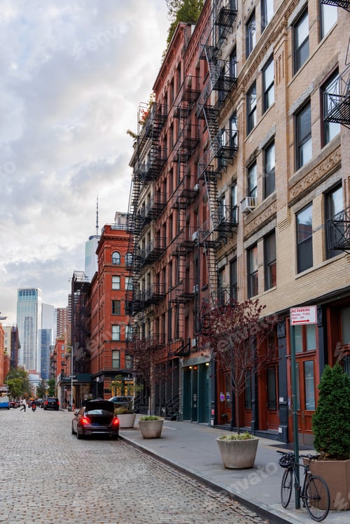 Preview: Captivating view of a bustling NYC Downtown street framed by iconic Manhattan skyscrapers