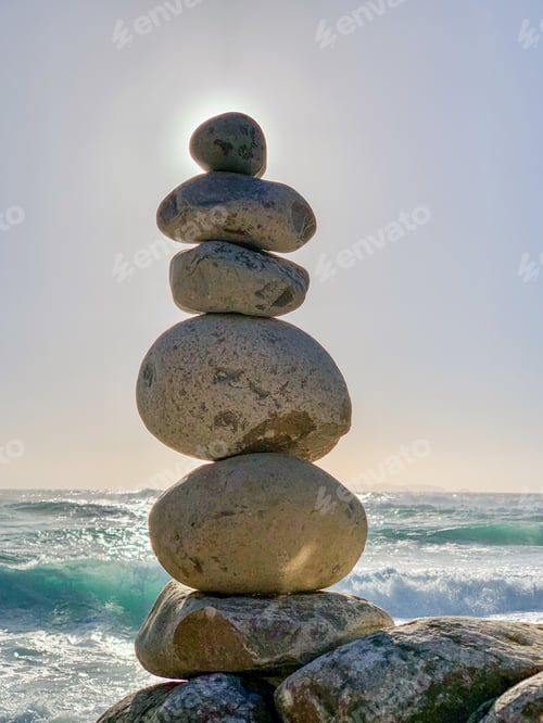 Preview: Vertical shot of balanced stones on a rocky shore