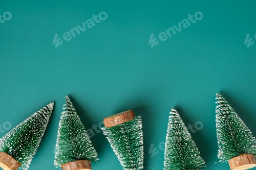 Preview: group of christmas tree lay on green backgorund top view