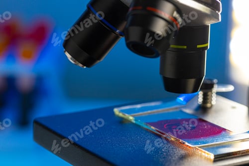 Preview: Close up photo of a microscope lenses examining glass sample