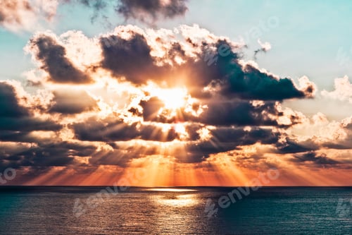 Preview: Beautiful wide shot of a sun shining between the clouds above the sea