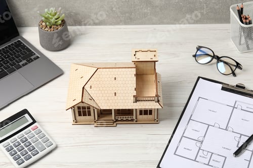 Preview: Real estate. House model, floor plan, calculator and laptop on white wooden table