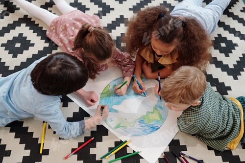 Preview: Cute kids drawing planet while lying on the floor