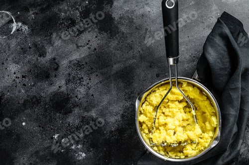 Preview: Cooking mashed potatoes in a pot. black background. top view. Copy space
