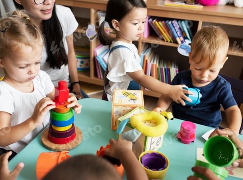 Preview: Nursery children playing with teacher in the classroom