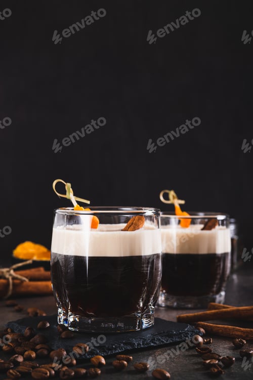 Preview: Spanish coffee cocktail with cinnamon and orange zest in glasses on table vertical view