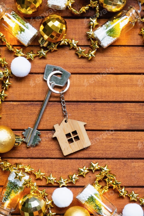 Preview: Key to house with a keychain tiny home on wooden background with Christmas decor layout. Gift for Ne