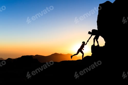 Preview: Teamwork couple climbing helping hand