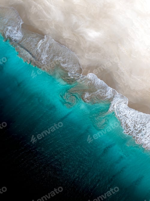 Preview: Aerial view of the sea waves rolling into a sandy shore in Western Australia.