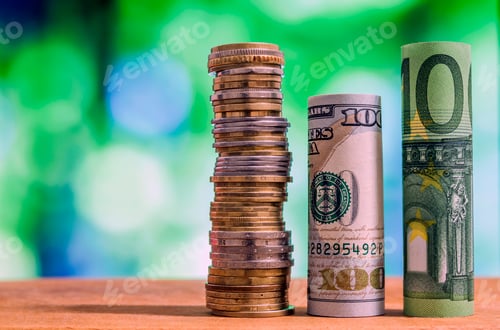Preview: One hundred euro and one hundred US dollar rolled bills banknotes, with euro coins