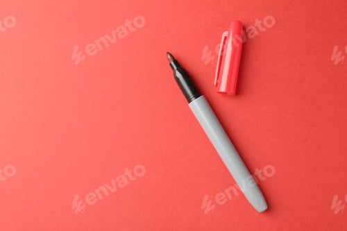 Preview: One color marker on red background, top view. Space for text