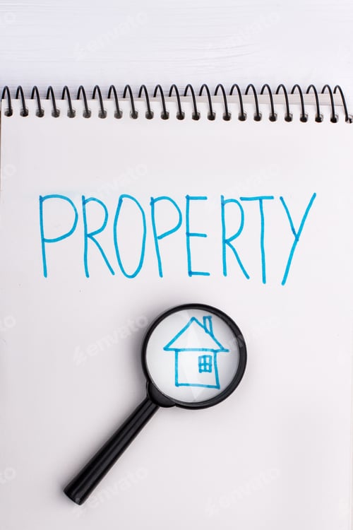 Preview: House and magnifying glass on notepad.