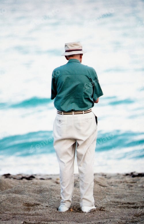 Preview: Man gazing at the sea, lost in thought.