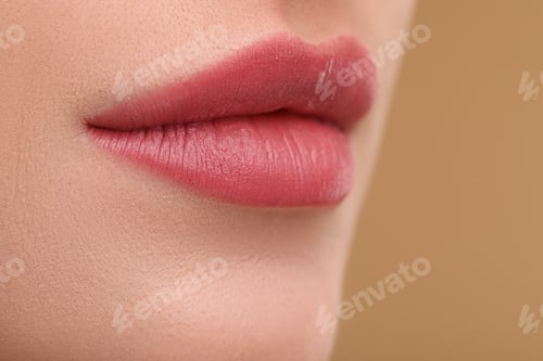 Preview: Young woman with beautiful full lips on beige background, closeup