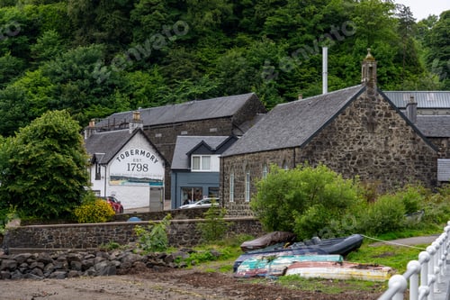 Preview: Tobermory distillery established in 1798 with lush green surroundings and old stone buildings