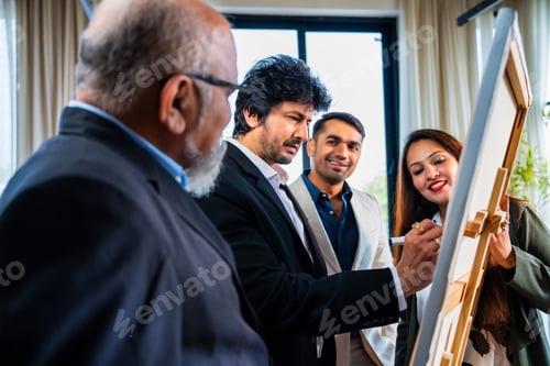 Preview: Indian Asian Businessman explaining a strategic plan on a whiteboard while colleagues observe
