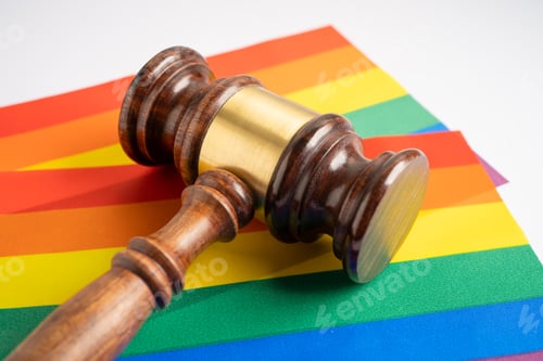 Preview: Gavel for judge lawyer on rainbow flag, symbol of LGBT pride month celebrate annual in June.