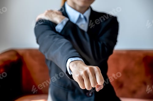 Preview: Successful businesswoman feeling shoulder pain and stretching herself after working hard