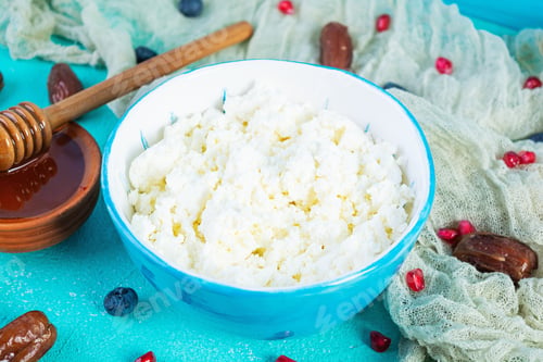 Preview: Cottage cheese with honey and berries on blue background. Light vegetarian breakfast