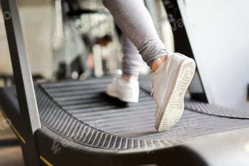 Preview: The feet of an Asian woman running on a treadmill