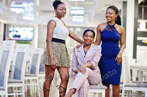 Preview: African woman in dress posing at restaurant